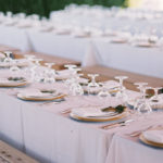 Elegant full table setting for outdoor wedding reception