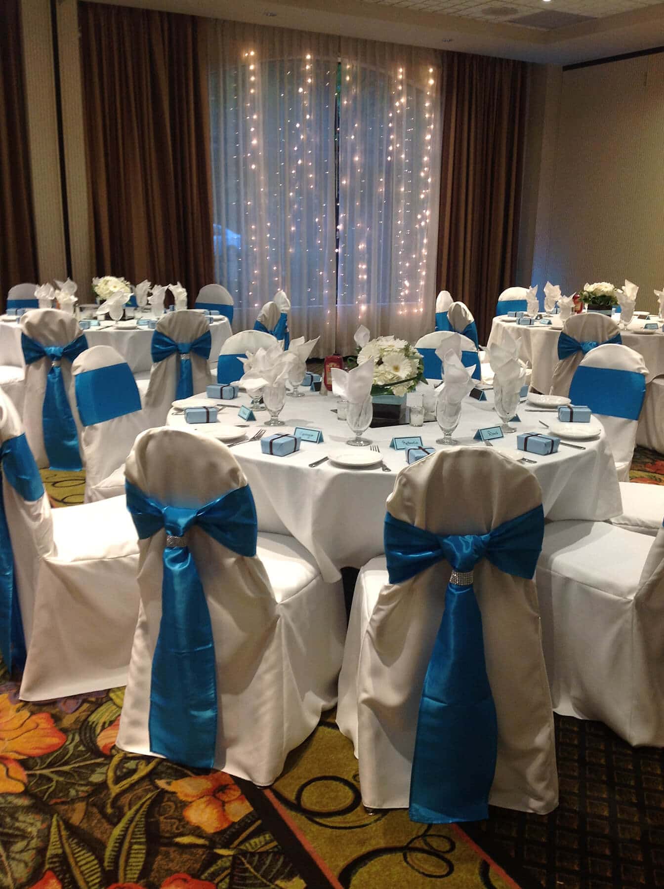 full dress table setting blue sashes on white chair covers