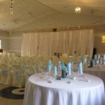 14-Yarrow Hall - ceiling lights and backdrop, chair covers and blue sashes